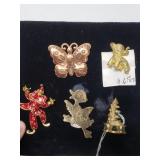 Themed metal brooches