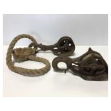Two old metal farm pulleys