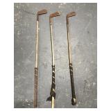 Three antique wood shaft golf clubs