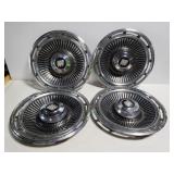 Four vintage Buick hubcaps