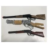 Three small toy shotgun cap guns