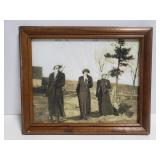 Old framed photo of woman with guns