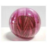 Colored glass round paperweight