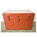 Small orange travel trunk