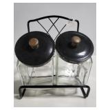 Two glass canisters on stand with lids