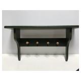 Rustic green wood wall shelf was pegs