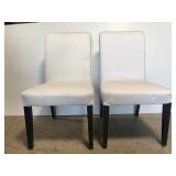 White covered modern armless chair pair