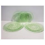 Five green translucent depression glass plates