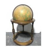 Large lighted globe on rolling floor stand
