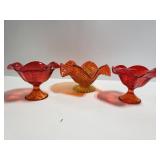 Three red glass ruffle candlestick holders