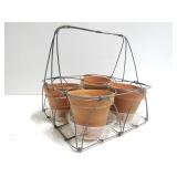 Metal wire carrier with small terracotta pots