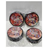 Four unopened RedWings hockey pucks