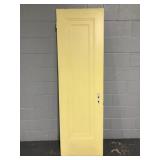 Yellow painted vintage narrow wood door