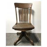Old wood desk chair on casters