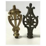 Two ornate scrolling metal finials