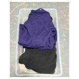 Storage bin of sweaters and pullovers