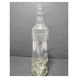 Glass bottle with metal base