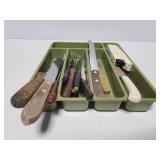 Knife collection in green organizer tray