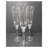 Three clear depression glass style flutes