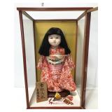 Porcelain Asian doll in traditional kimono