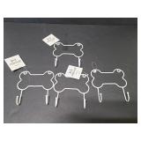 Four decorative dog bone hooks, white