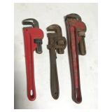 Three pipe wrenches, one is antique