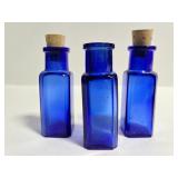Three small vintage cobalt blue glass bottles