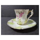 Tiny unmarked teacup and saucer