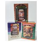 Three Budweiser steins in boxes
