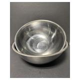 Two large stainless metal mixing bowls