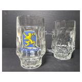 Pair of glass Löwenbräu beer mugs