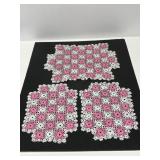 Three pink and white checkered doilies