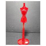 Small red plastic mannequin