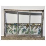 Old window pane with colored glass beads