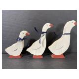 Trio of small painted wooden geese