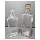 Two old glass medicine bottles