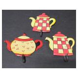 Trio of small metal wall kitchen hooks