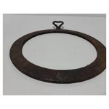 Circle cast iron piece with heart handle