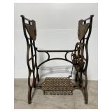 Antique cast iron sewing machine base on wheels