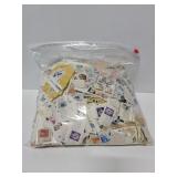 Large bag of postage stamps on paper