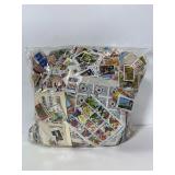 Large bag of postage stamps on paper