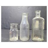 Three small glass bottles
