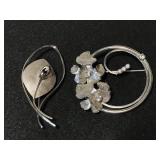 Pair of silver toned brooches