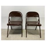 Pair of brown metal folding chairs