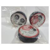 Three Detroit Red Wings player pucks
