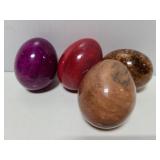 Four polished stone eggs