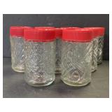 Lot of 8 vintage embossed glass jars w/ twist tops