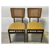 Pair of MCM Stackmore Co. cane back folding chairs