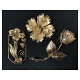 Trio of bronze colored floral brooches