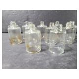 Eleven small glass candle snuffers